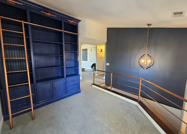 a view of an empty room with empty shelves