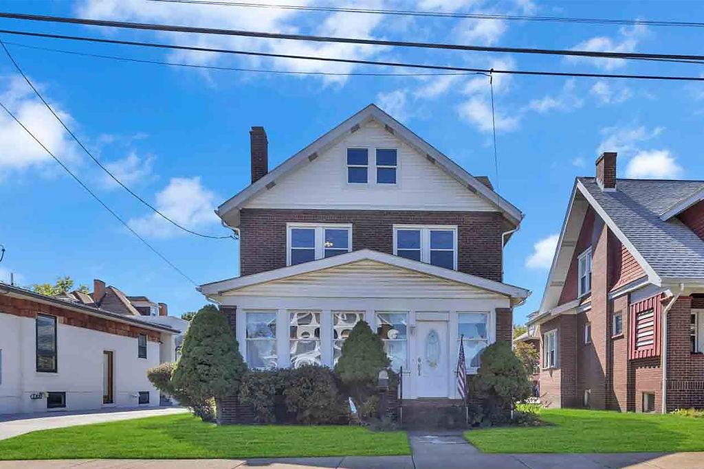 938 Atlantic Avenue Monaca, PA 15061 - Photo 1 of 24 a front view of a house with garden