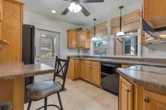 a kitchen with a table chairs sink and cabinets