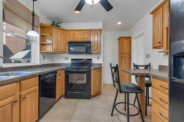 a kitchen with stainless steel appliances a stove sink and microwave
