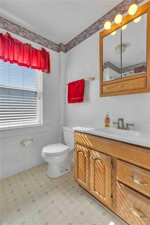 938 Atlantic Avenue Monaca, PA 15061 - Photo 13 of 24 a bathroom with a toilet a sink and a mirror