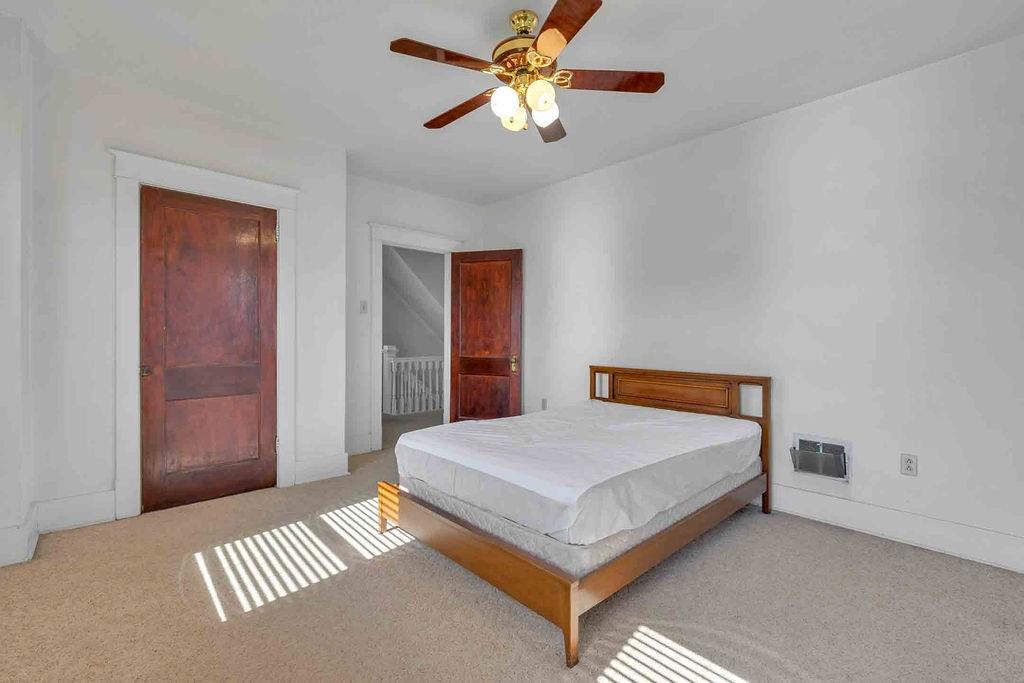 938 Atlantic Avenue Monaca, PA 15061 - Photo 16 of 24 a bedroom with a bed and a chandelier