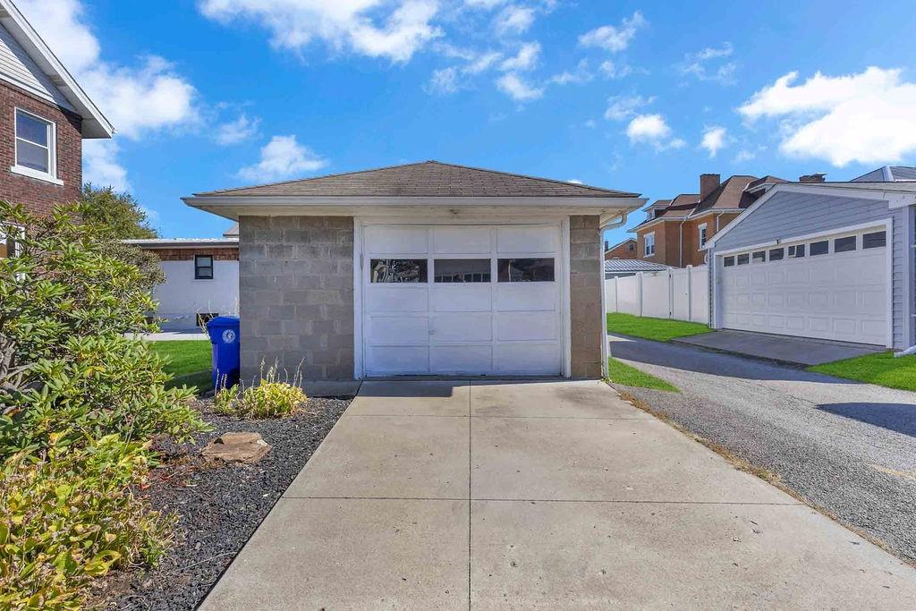 938 Atlantic Avenue Monaca, PA 15061 - Photo 22 of 24 a front view of a house with a yard and garage
