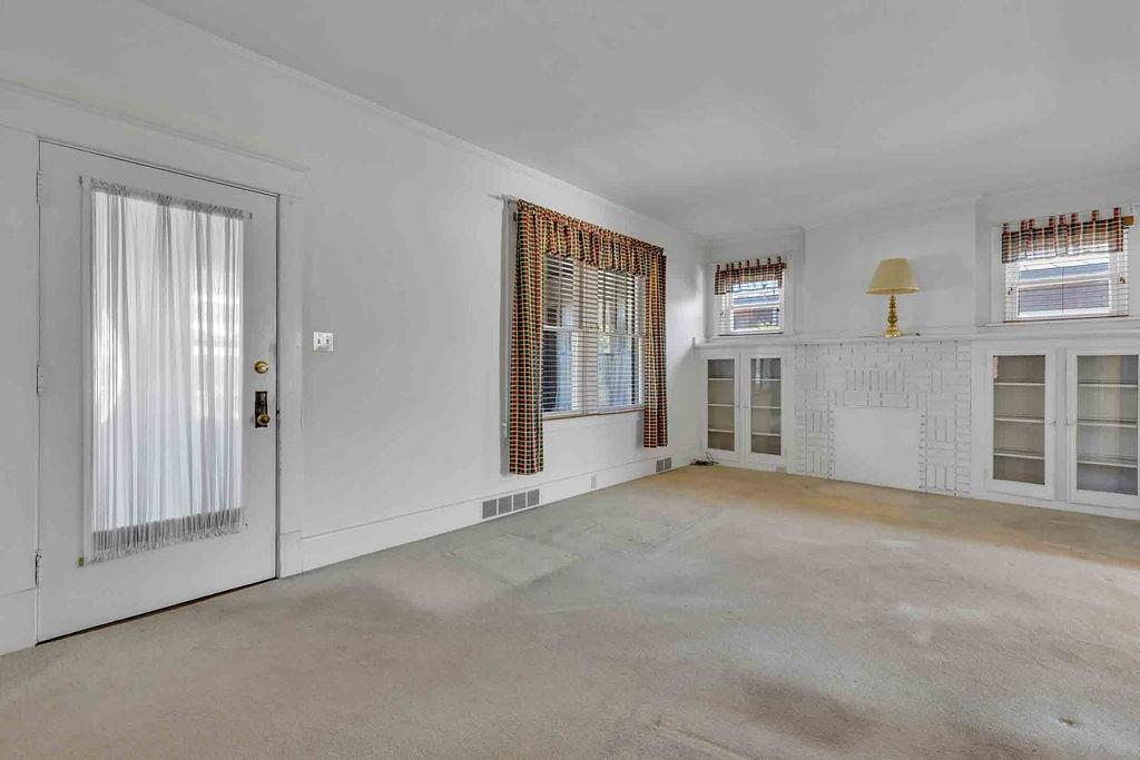 938 Atlantic Avenue Monaca, PA 15061 - Photo 7 of 24 a view of empty room with windows and fireplace