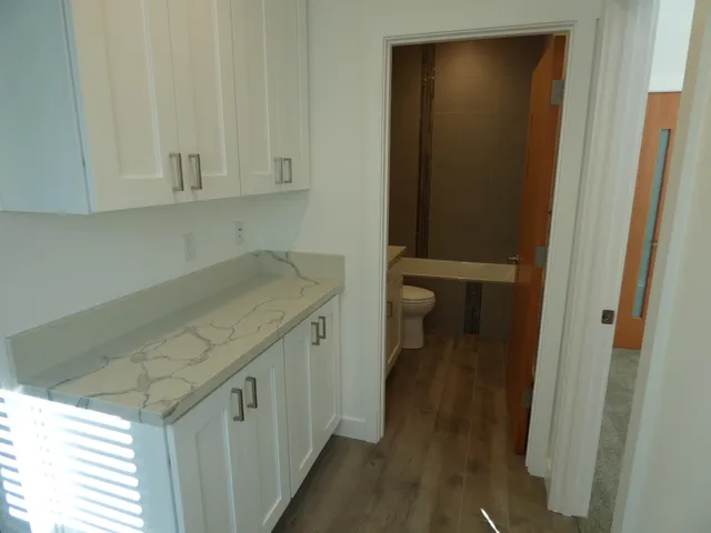 a view of a bathroom with sink and wooden floor