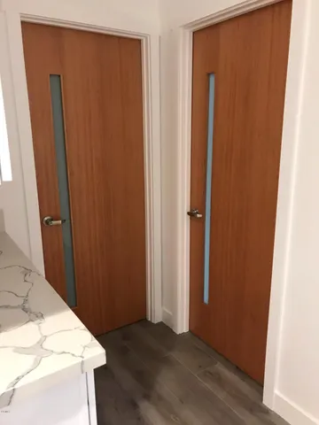 a view of a kitchen with wooden floor and washing machine