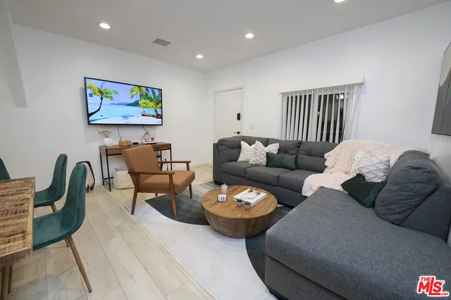 a living room with furniture a rug and a painting