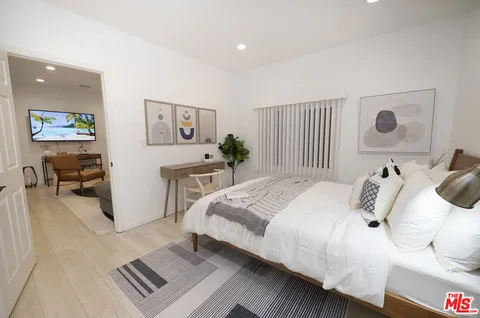 a bedroom with a bed and a desk