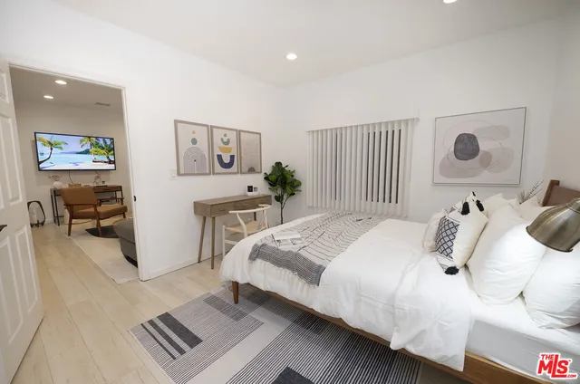 a bedroom with a bed and a desk