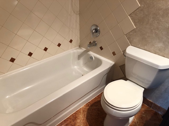725 West Huntington Commons Road, Unit 401 Mount Prospect, IL 60056 - Photo 11 of 13 a white toilet sitting next to a bath tub