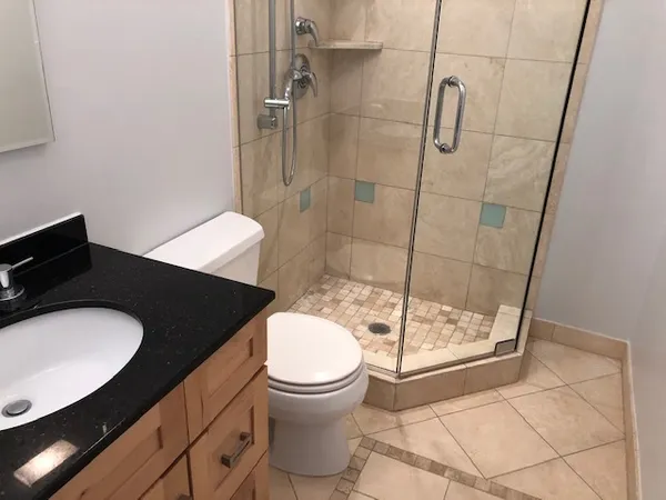 a bathroom with a sink toilet and shower