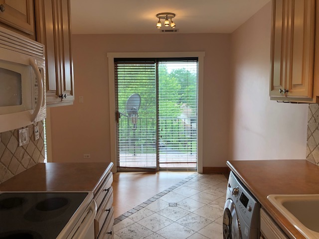 725 West Huntington Commons Road, Unit 401 Mount Prospect, IL 60056 - Photo 4 of 13 a view of a kitchen with a sink and dishwasher
