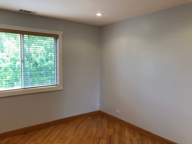 725 West Huntington Commons Road, Unit 401 Mount Prospect, IL 60056 - Photo 8 of 13 an empty room with a window