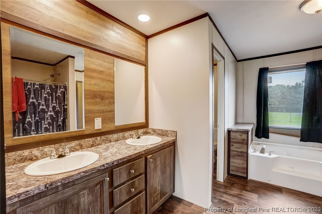 461 Reedsford Road Clinton, NC 28328 - Photo 15 of 27 a bathroom with a granite countertop sink and a mirror