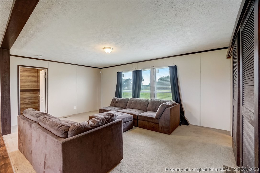 461 Reedsford Road Clinton, NC 28328 - Photo 3 of 27 a living room with furniture and a floor to ceiling window