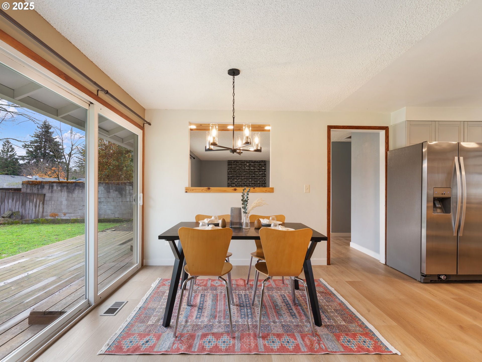 824 Southeast 207th Avenue Gresham, OR 97030 - Photo 14 of 47 a dining room with furniture a chandelier and wooden floor