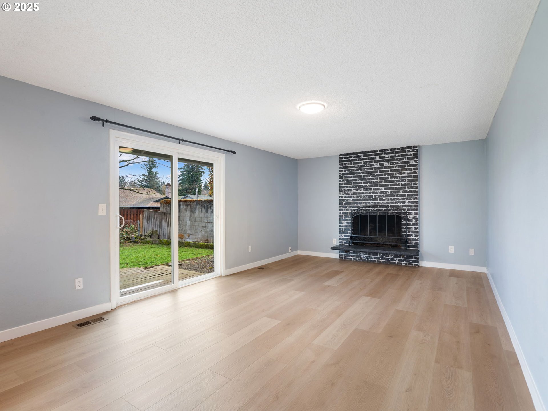 824 Southeast 207th Avenue Gresham, OR 97030 - Photo 20 of 47 an empty room with floor to ceiling window and fireplace