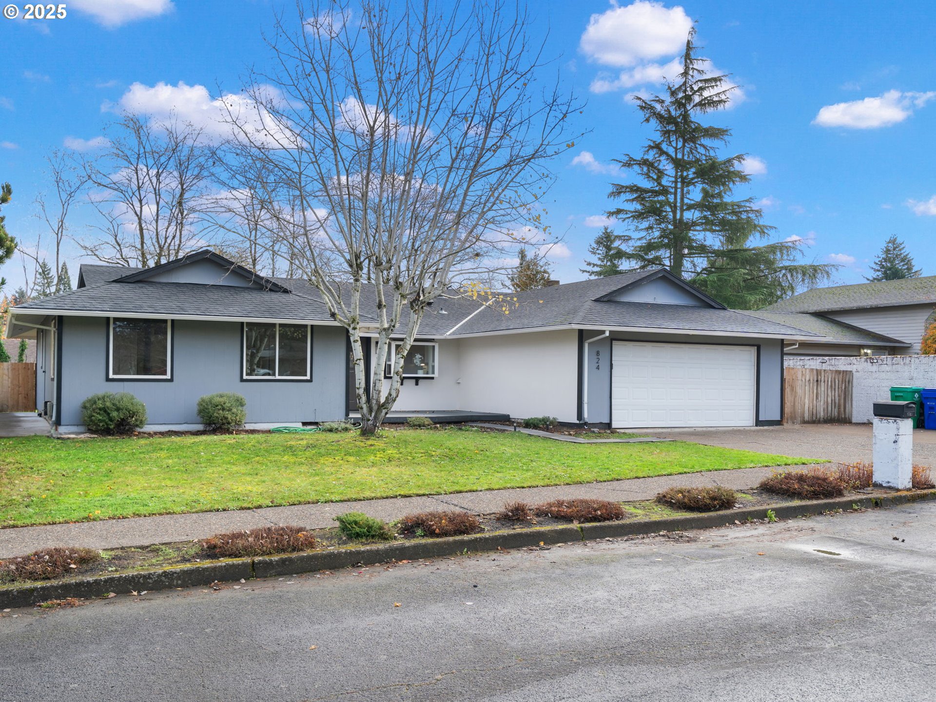 824 Southeast 207th Avenue Gresham, OR 97030 - Photo 2 of 47 a front view of a house with a yard and garage