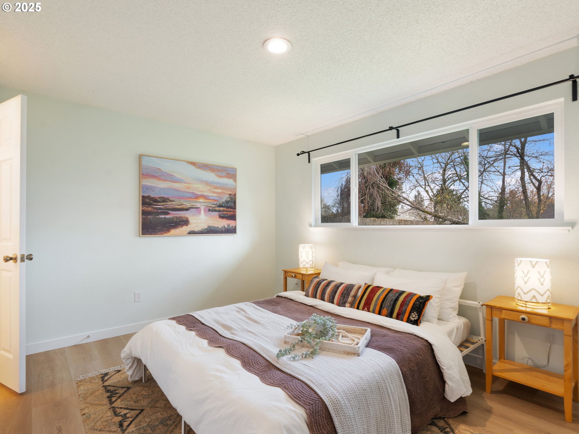 824 Southeast 207th Avenue Gresham, OR 97030 - Photo 25 of 47 a bedroom with a bed and wooden floor