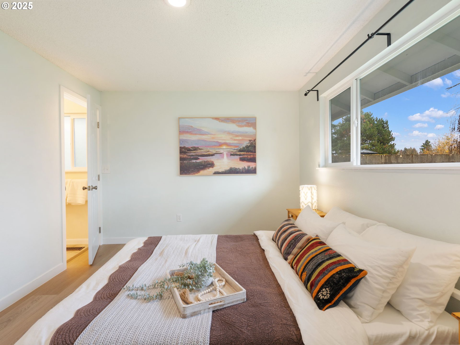 824 Southeast 207th Avenue Gresham, OR 97030 - Photo 26 of 47 a bedroom with a bed and a painting on the wall