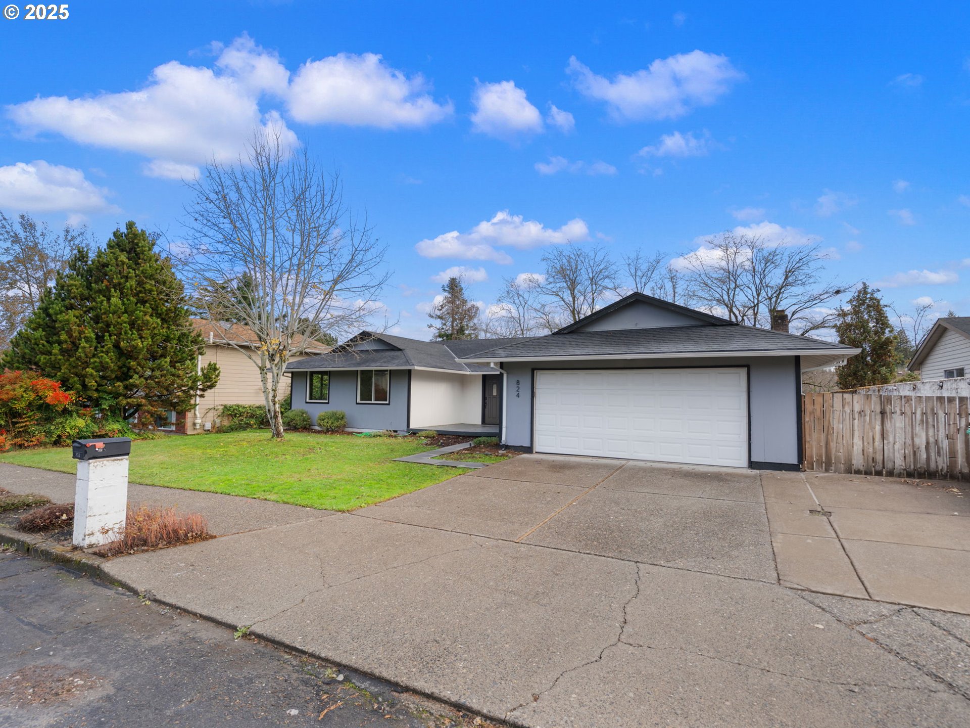 824 Southeast 207th Avenue Gresham, OR 97030 - Photo 3 of 47 a view of a house with a yard and garage