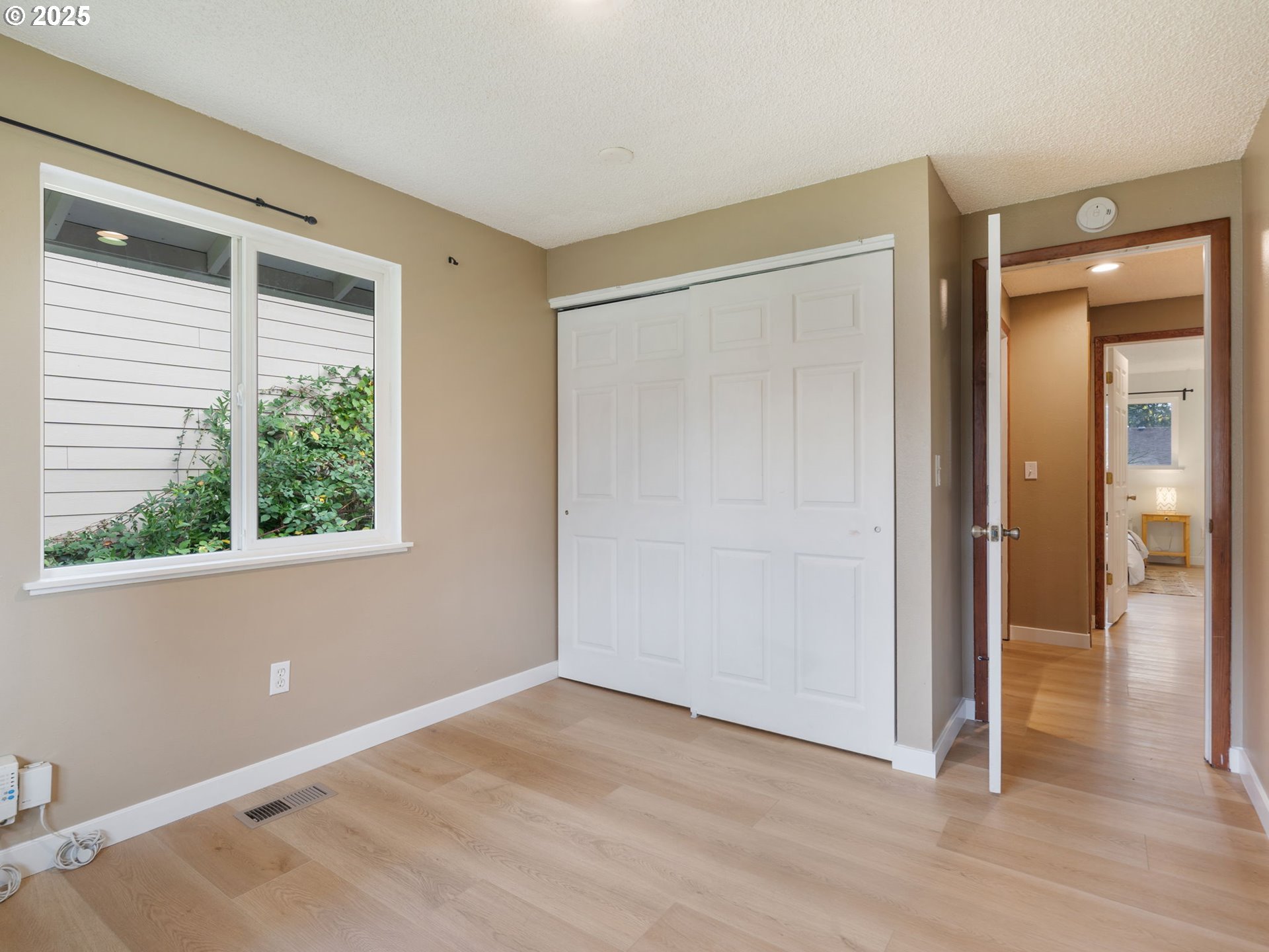824 Southeast 207th Avenue Gresham, OR 97030 - Photo 33 of 47 a view of an empty room with wooden floor and a window