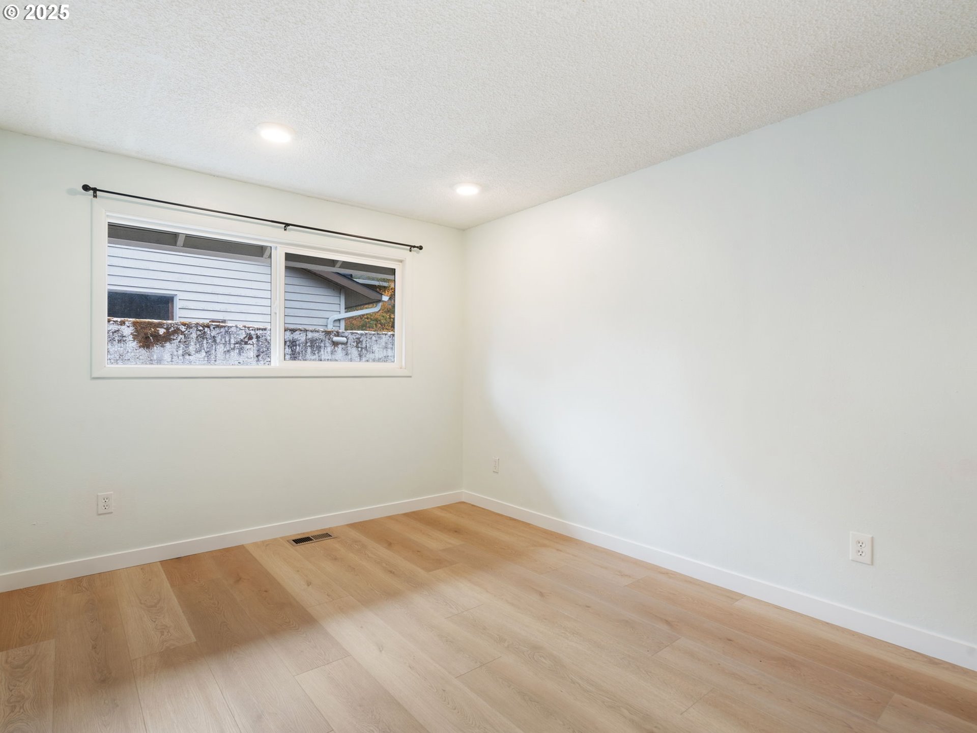 824 Southeast 207th Avenue Gresham, OR 97030 - Photo 35 of 47 a view of a big room with wooden floor and windows