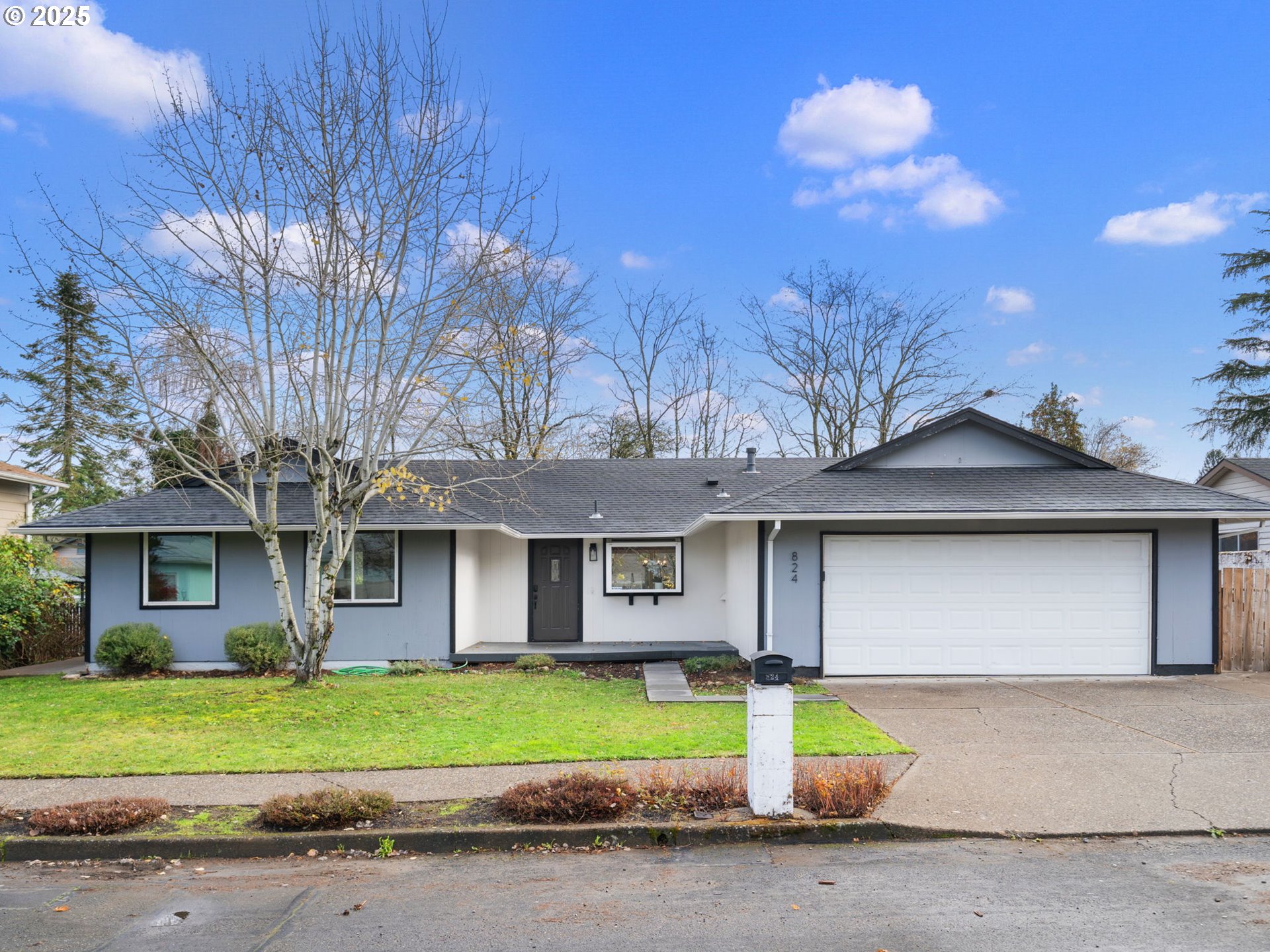 824 Southeast 207th Avenue Gresham, OR 97030 - Photo 4 of 47 a front view of a house with a garden and plants