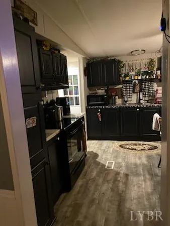 a kitchen with a refrigerator and a stove