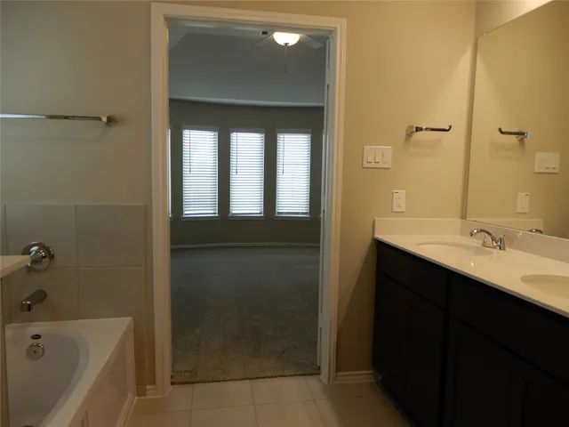 a spacious bathroom with a bathtub and a shower