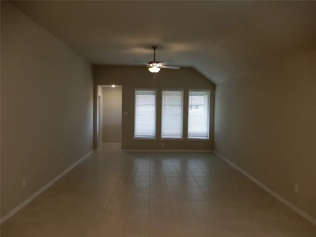 a view of living room with kitchen island stainless steel appliances wooden floor and window