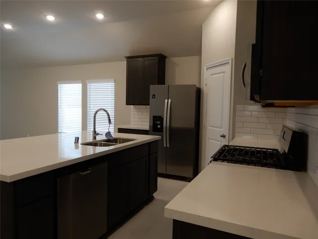 a kitchen with a cabinets and a refrigerator