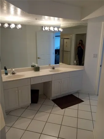 a spacious bathroom with a sink vanity and mirror