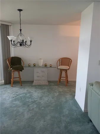 a room with a chair and a chandelier
