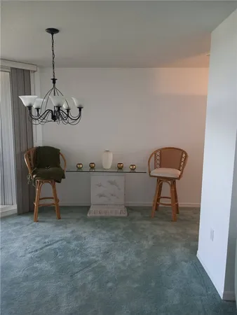 a view of a room with a table and chairs