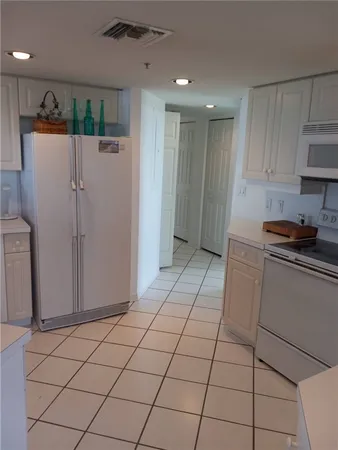 a kitchen with stainless steel appliances granite countertop a refrigerator and a stove