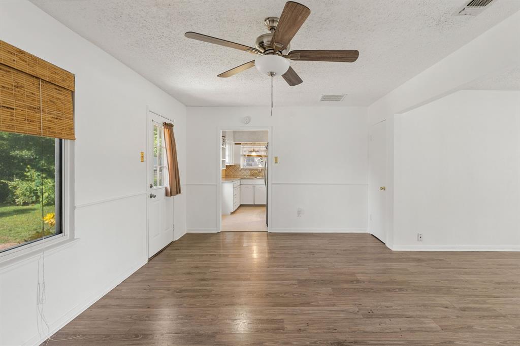 1822 Finley Road Irving, TX 75062 - Photo 19 of 38 a view of empty room with wooden floor and fan
