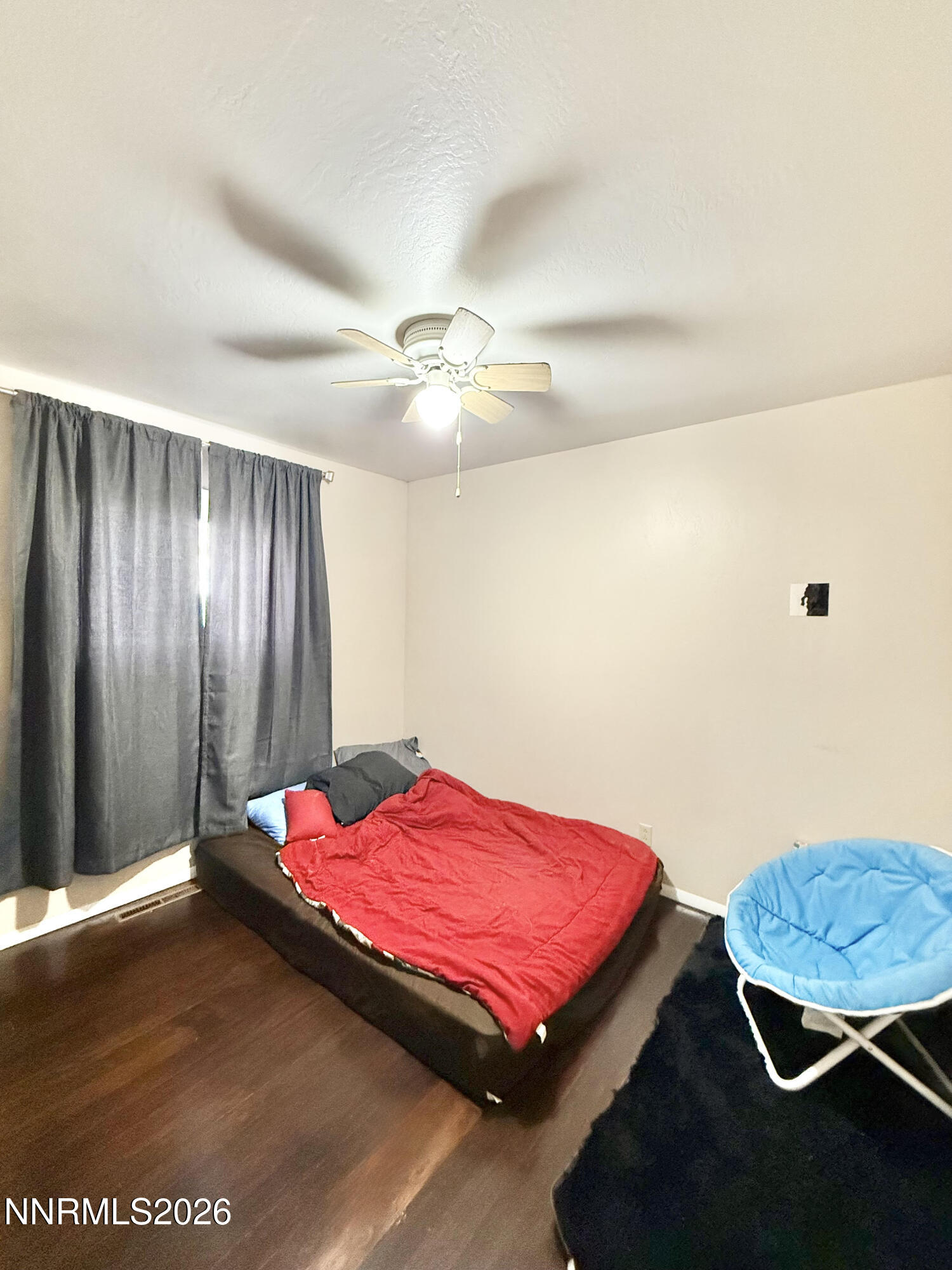 68 West 5th Street Battle Mountain, NV 89820 - Photo 19 of 20 a bedroom with a bed and a chandelier