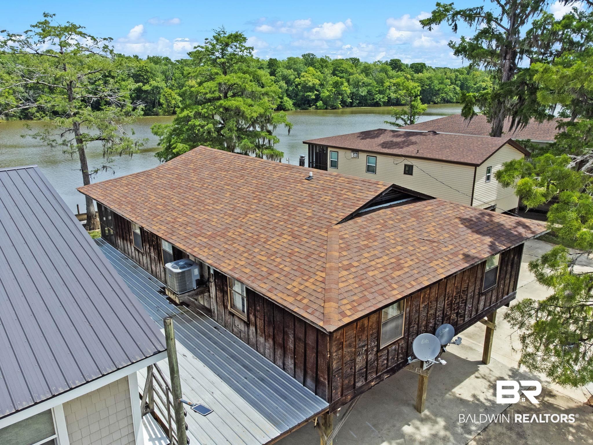 8153 Bryant's Lndg Road Stockton, AL 36579 - Photo 8 of 87 Elevated wood-sided structure featuring a shingle roof and multiple windows