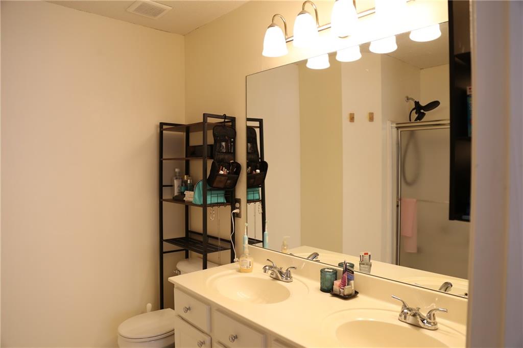 3767 Berkeley Crossing Duluth, GA 30096 - Photo 14 of 23 a bathroom with a sink vanity mirror and toilet