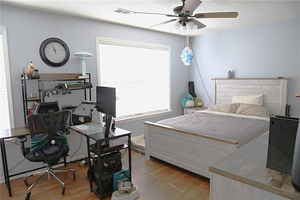 3767 Berkeley Crossing Duluth, GA 30096 - Photo 15 of 23 a bedroom with a bed and a chandelier