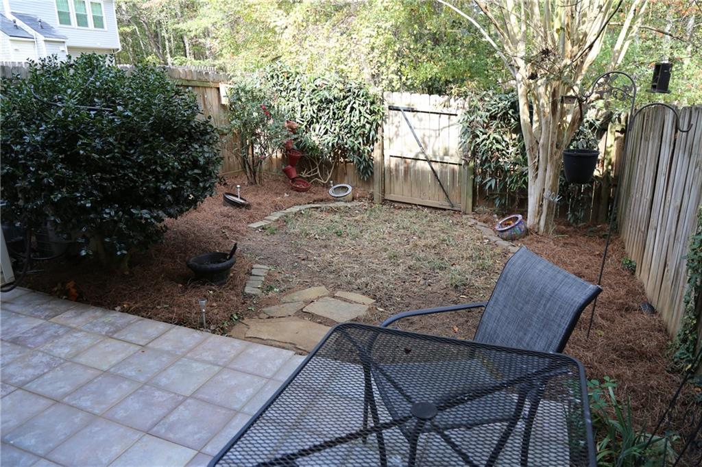 3767 Berkeley Crossing Duluth, GA 30096 - Photo 21 of 23 a view of backyard with table and chairs and potted plants