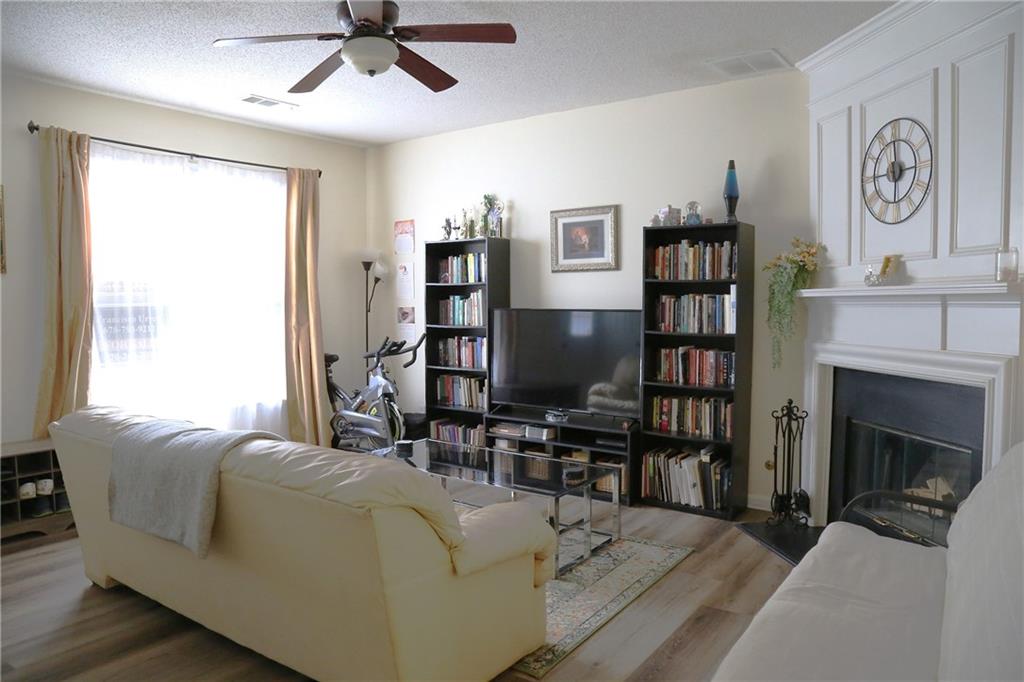 3767 Berkeley Crossing Duluth, GA 30096 - Photo 5 of 23 a living room with furniture and a fireplace
