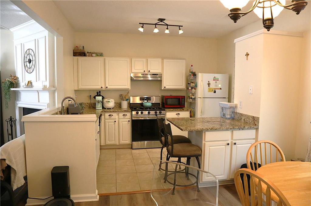 3767 Berkeley Crossing Duluth, GA 30096 - Photo 9 of 23 a kitchen with a sink appliances and cabinets