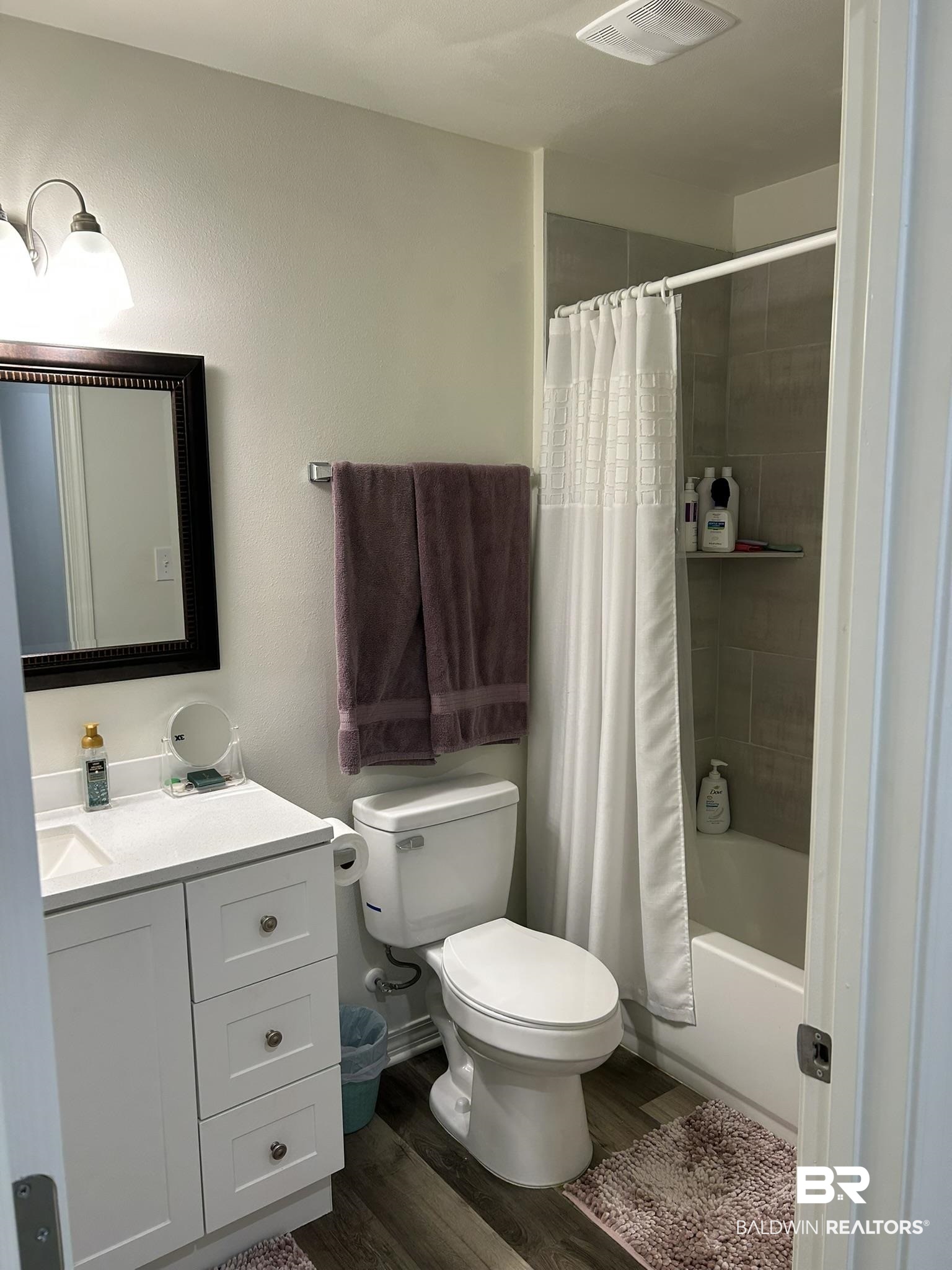 2 Canterberry Circle Foley, AL 36535 - Photo 15 of 24 Full bathroom featuring toilet, wood finished floors, vanity, visible vents, and shower / bath combo with shower curtain