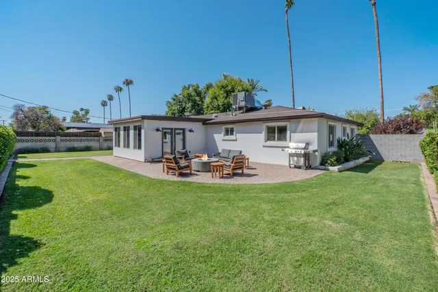 a view of a house with swimming pool yard patio and fire pit