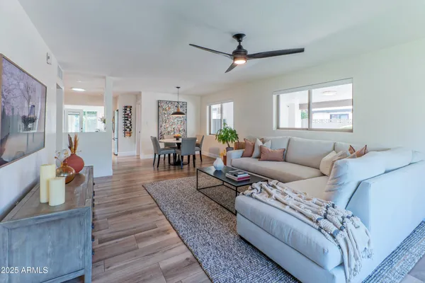 a living room with furniture and a wooden floor