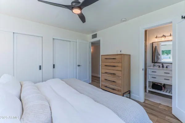 a bedroom with a bed and a dresser