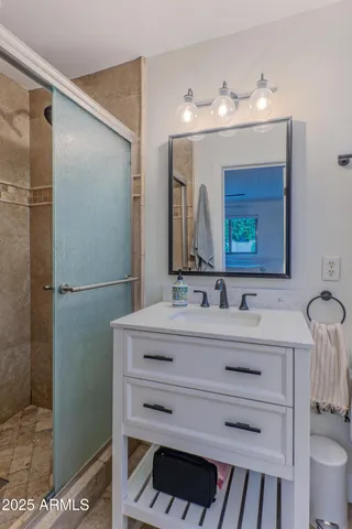 a bathroom with a sink vanity and a mirror