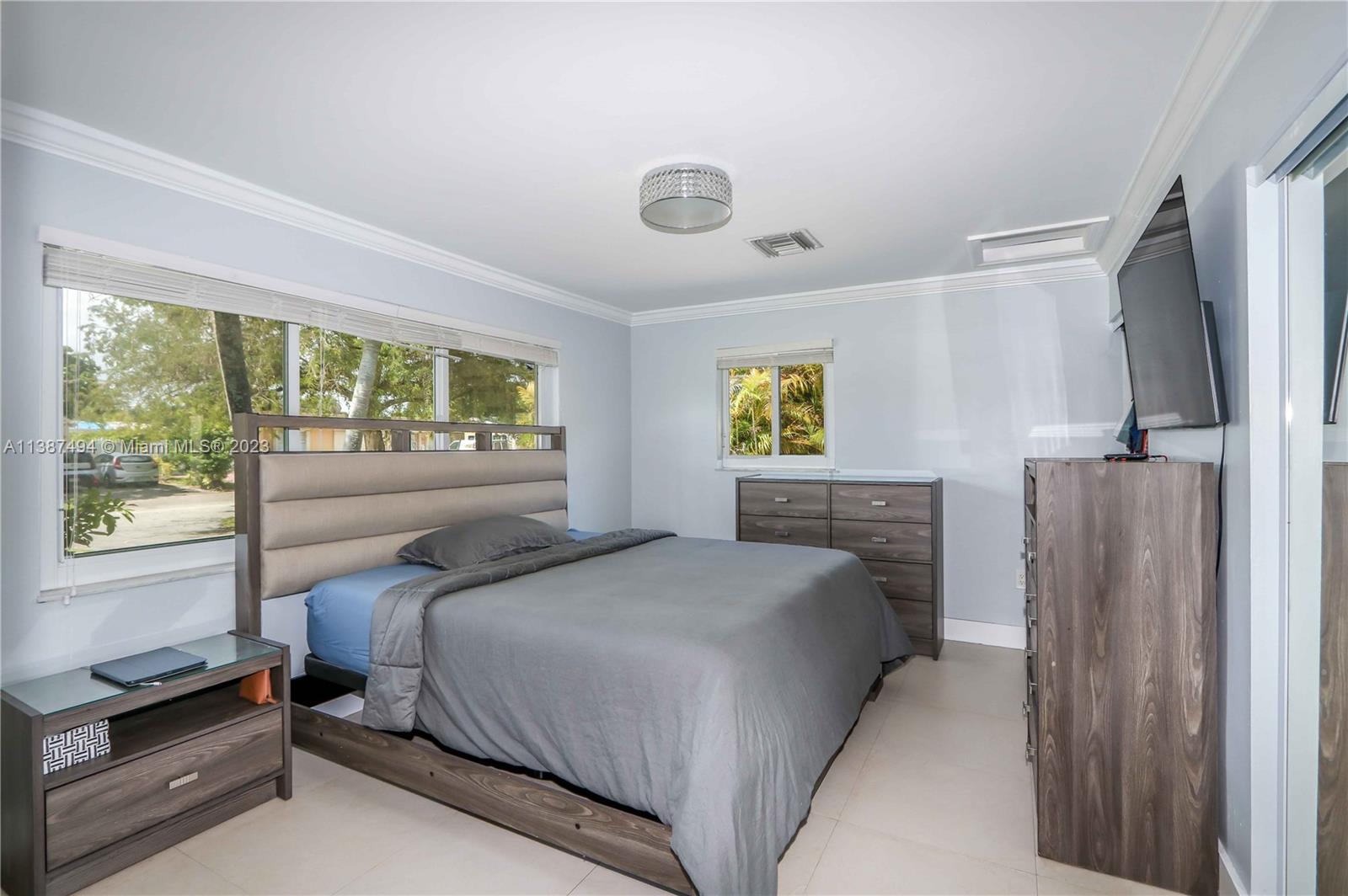 9275 Southwest 45th Street Miami, FL 33165 - Photo 13 of 23 a bedroom with a bed and a window